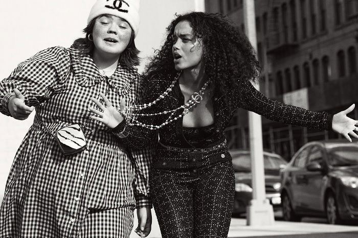 Two young women walking in a city street