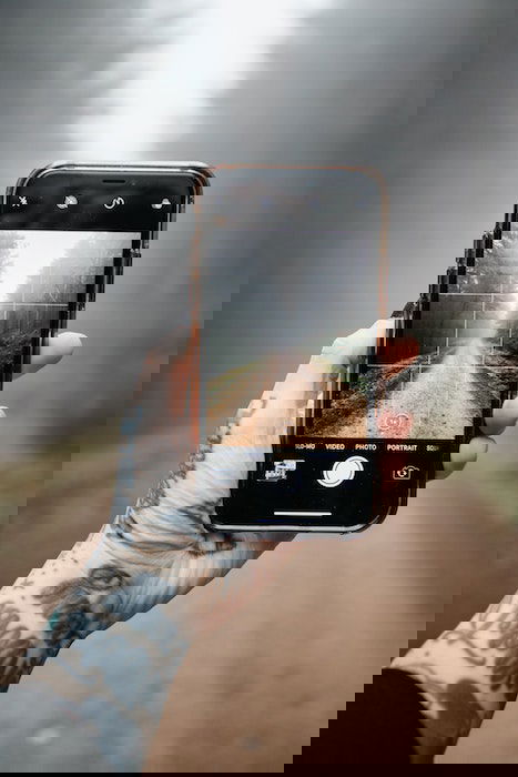 person using a grip to take a photo of a path 