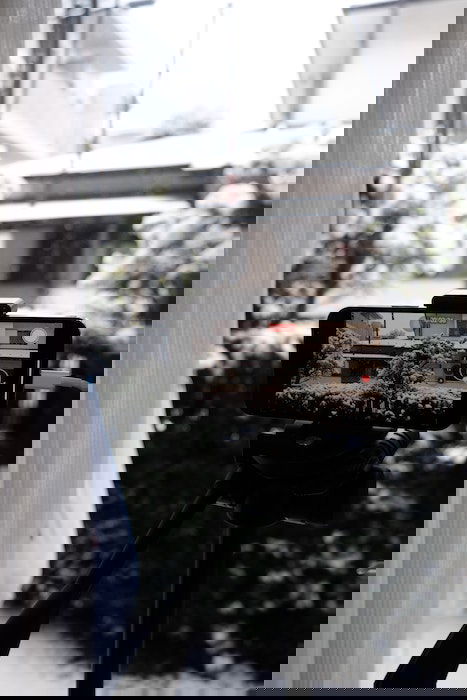 phone on tripod taking video of the snow