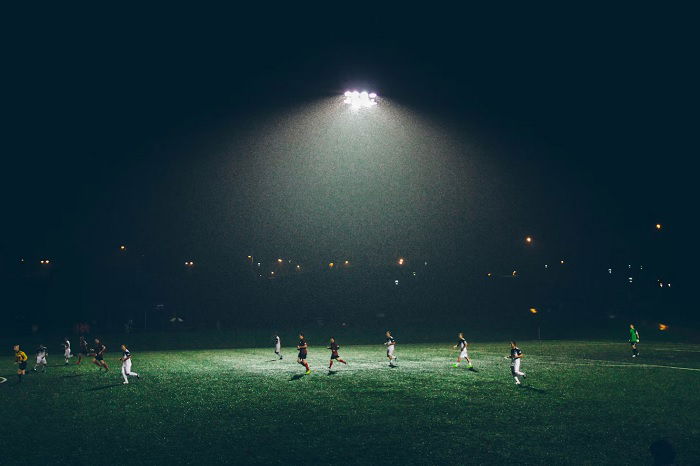 Wide shot of floodlit football match