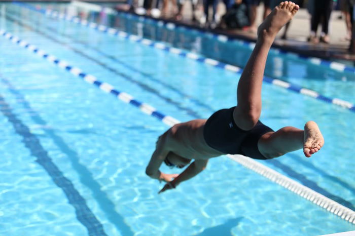 Swimmer diving into swimming pool