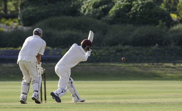Shot of a cricket batsman hitting the ball