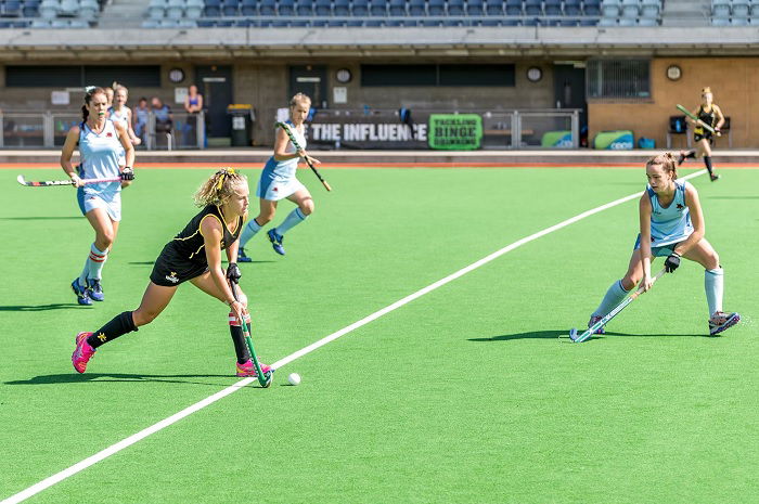 Pitch-side shot of women's field hockey match
