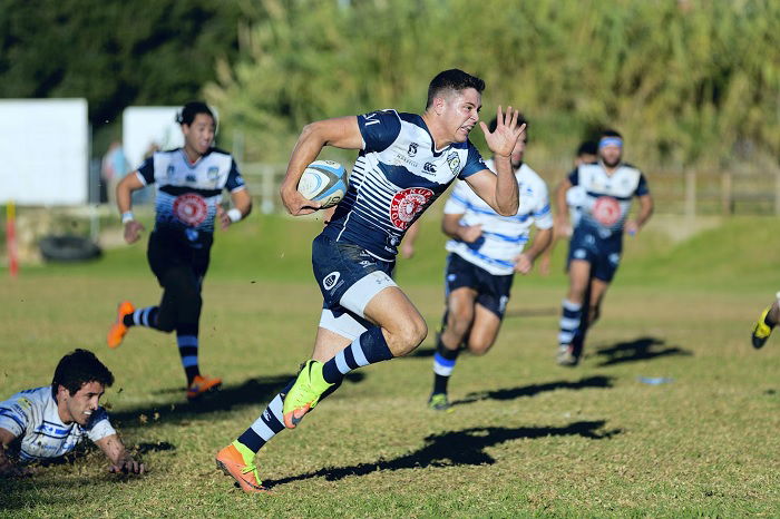 Rugby player making a break with ball in hand