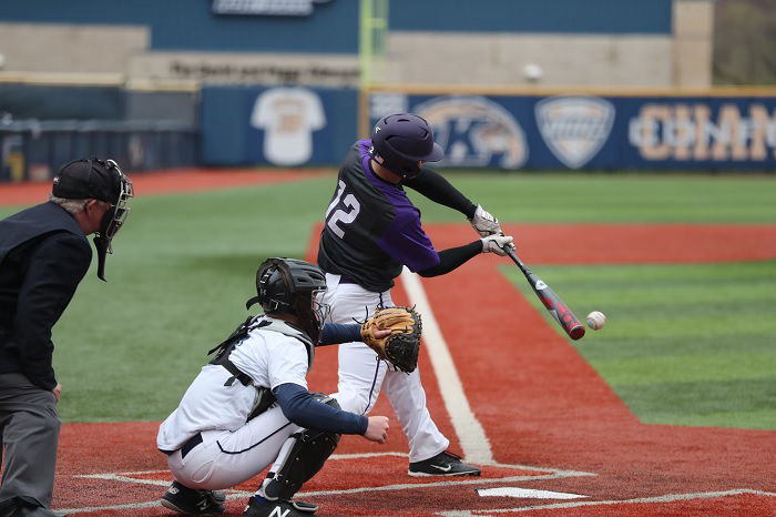Baseball player hitting the ball with his baseball bat